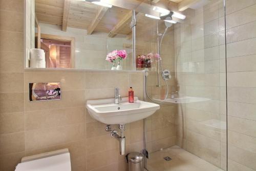 a bathroom with a sink and a shower at Balthazar The Loft by Villars Luxury in Villars-sur-Ollon