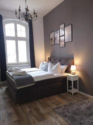a bedroom with a large bed and a window at Pension Zur Alten Post in Havelberg