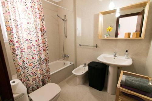 a bathroom with a sink toilet and a shower curtain at Apartamento San Remo Soleado in Palm-Mar