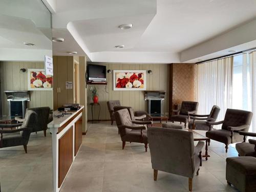 a waiting room with chairs and a table in a hospital at Novator Playa in Mar del Plata