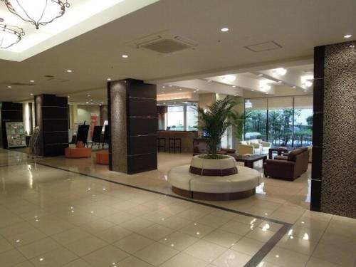a lobby with a potted plant in the middle of a building at Hotel Taisei Annex - Vacation STAY 04753v in Kagoshima