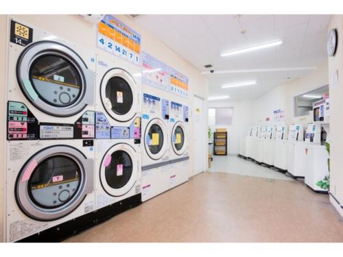 a laundry room with several washing machines on the wall at Hotel Taisei Annex - Vacation STAY 04753v in Kagoshima