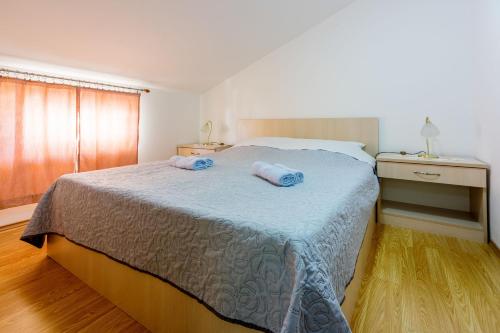 a bedroom with a bed with two towels on it at Apartments Marissimo in Crikvenica