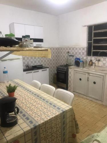 a large kitchen with a table and chairs in it at Pousada Fran in Sao Paulo