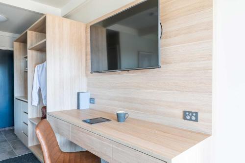 a bathroom with a wooden vanity with a mirror at Panorama Bathurst in Bathurst
