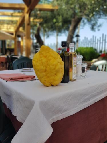 a yellow flower sitting on top of a table at Villa Antonino in Giardini Naxos