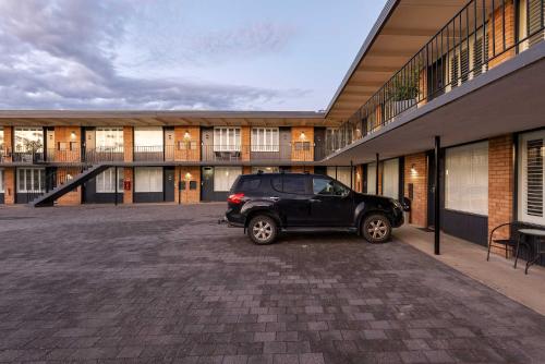 a black suv parked in front of a building at Panorama Bathurst in Bathurst