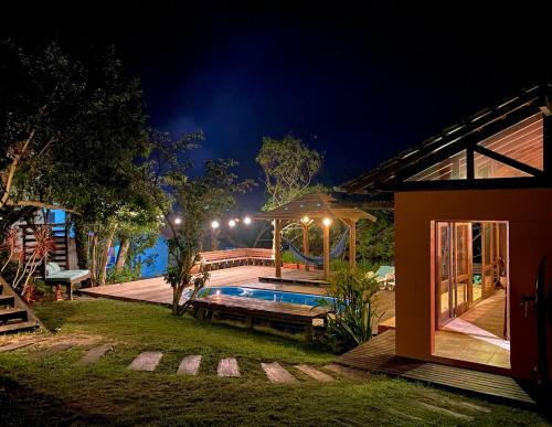 a house with a swimming pool at night at Pueblo Rosa Norte in Praia do Rosa