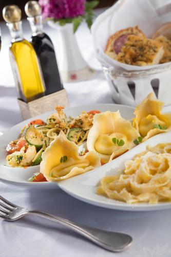 a plate of food with pasta on a table at Presidente InterContinental Mexico City by IHG in Mexico City