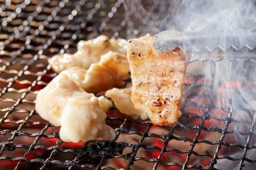 a piece of food is cooking on a grill at Tabist THE GREEN ASAHIKAWA in Asahikawa
