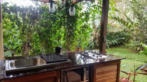 a kitchen that has a sink and a counter top at Tacacori EcoLodge in Alajuela