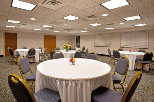 a conference room with tables and chairs with flowers on them at Holiday Inn Express Hotel & Suites-Saint Joseph by IHG in Saint Joseph