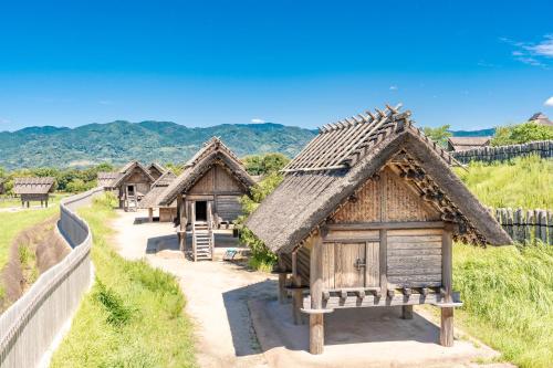 a group of small wooden houses on a hill at Sun Hotel Tosu Saga in Tosu
