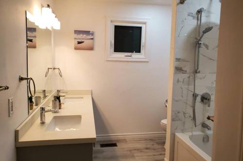 a bathroom with a sink and a shower at Cottage with River Front & minutes away from Beach in Wasaga Beach