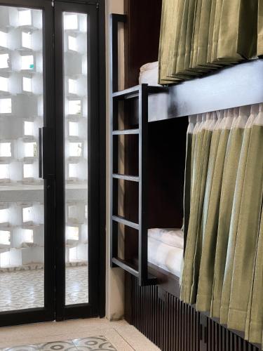 a bunk bed in a room with a window at Aborest Tropical Hostel in Siem Reap