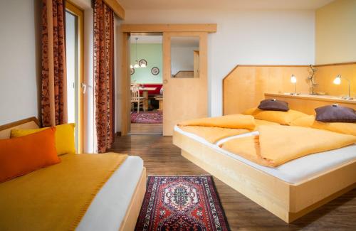 a bedroom with two beds and a couch at Ferienhaus Sonnenhang in Matrei in Osttirol