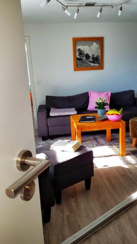 a living room with a couch and a table at Ferienhaus Linder in Fischen