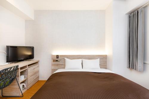 Cama o camas de una habitación en The OneFive Fukuoka Tenjin