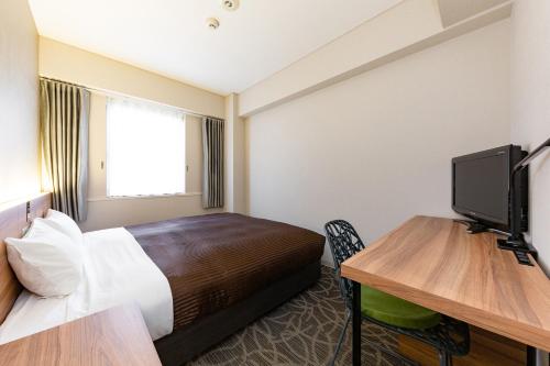 Cama o camas de una habitación en The OneFive Fukuoka Tenjin