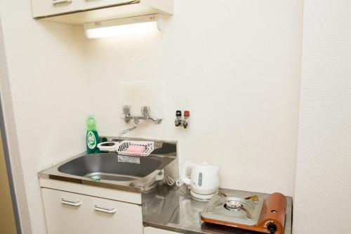 a small bathroom with a sink and a toilet at 102 Uzumasa Arashiyama 2free Bike Wifi in Sagano