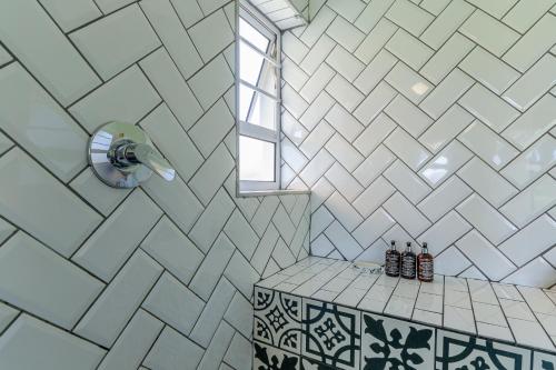 a bathroom with a shower with a table and a window at Wildlife Retreat on a Wine-Farm in Stellenbosch