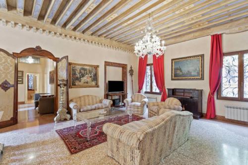 a living room filled with furniture and a chandelier at Doge Palace Luxury Apartment - Cannaregio in Venice