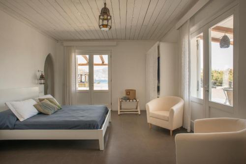a bedroom with a bed and a chair at Mari del Sud Resort in Vulcano