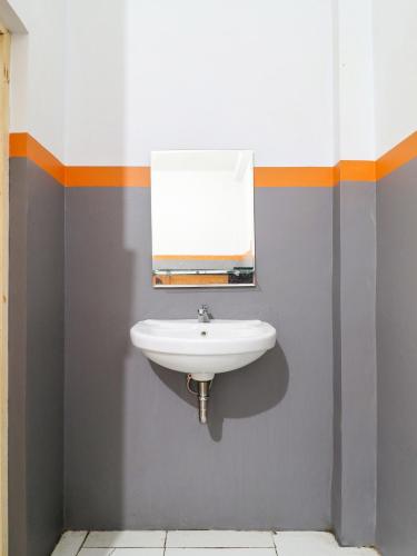 a bathroom with a sink and a mirror at RedDoorz At Merdeka Street Garut in Garut