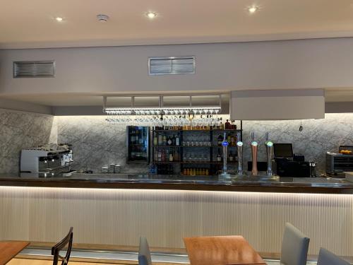 a bar in a restaurant with a counter at Hotel Unzaga Plaza in Éibar
