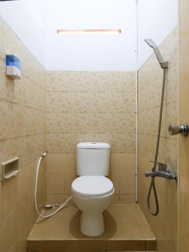 a bathroom with a toilet and a shower at RedDoorz At Merdeka Street Garut in Garut