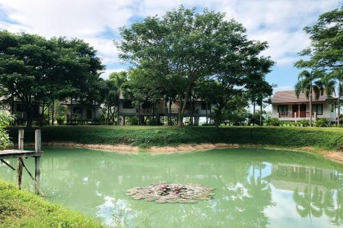 a pond with a bunch of flowers in the water at Resort Railumpoo (Farm and Camping) in Nakhon Sawan