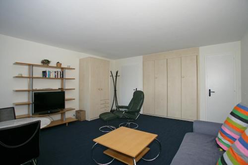 a living room with a couch and a table at Apartments Haus Quelle in Leukerbad