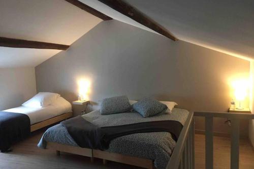 En eller flere senge i et værelse på Maison accueillante