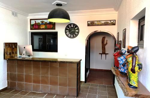 a kitchen with a counter and a clock on the wall at Hotel Blawa in Abidjan