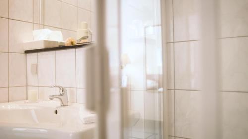 a bathroom with a sink and a shower at Hotel Blankenfeld in Wetzlar