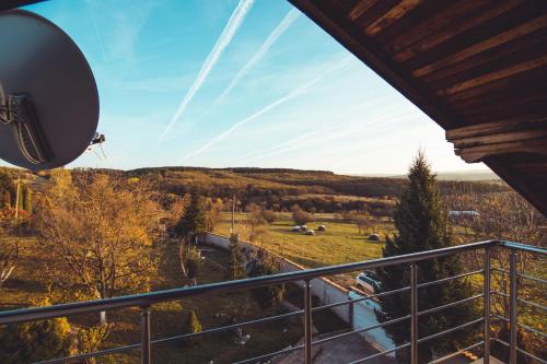 a balcony with a view of a field and trees at Villa Villekulla in Chukovezer