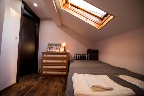 a bedroom with a bed and a skylight at Villa Villekulla in Chukovezer