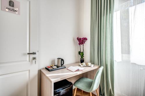 a desk with a chair next to a window at Oasi Urbana 41 in Rome