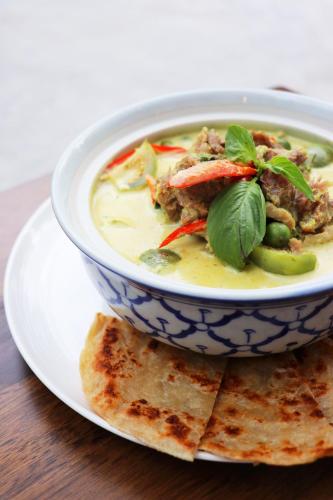 a bowl of soup sitting on a plate with some bread at W Station in Bangkok