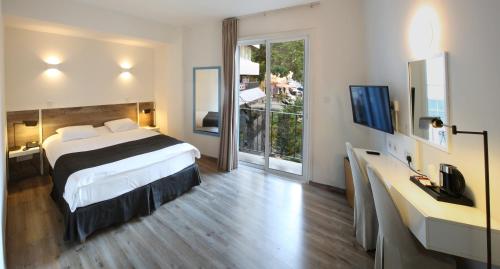 a hotel room with a large bed and a television at Centrum Hotel - City Center in Nicosia