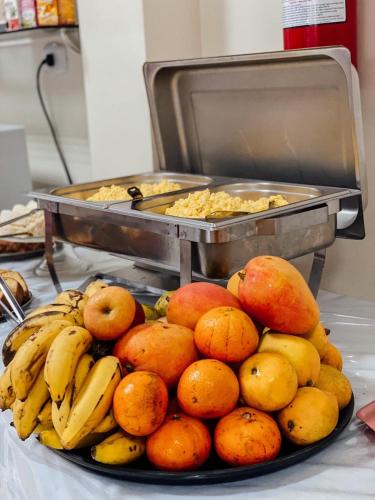 a pile of fruit on a plate on a table at Hotel Borari in Alter do Chao