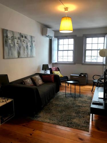 a living room with a couch and a table at Casa Santa Luzia - Historic Centre in Guimarães