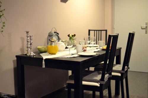 a black dining room table with glasses on it at Appartbrussels in Brussels