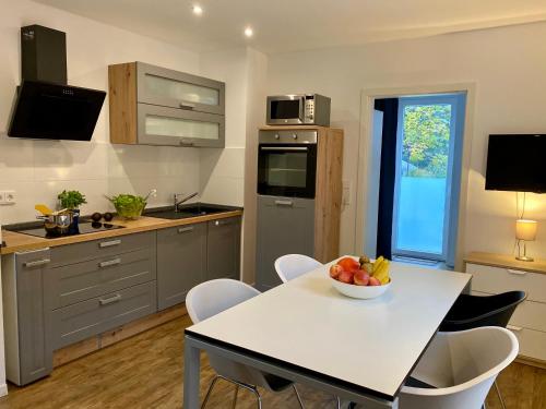 una cocina con una mesa con un bol de fruta. en Apartment End, en Heidelberg