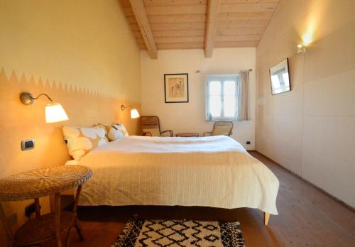 a bedroom with a large bed and a window at Ferrarotti in Clavesana