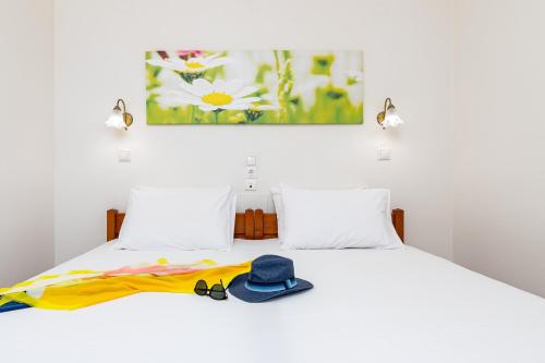 a bedroom with a bed with a hat and a towel at Mylos Apartments Anissaras in Hersonissos