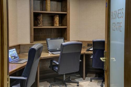 an office with a desk with a laptop and chairs at Manor Hotel Solihull, BW Signature Collection in Bickenhill