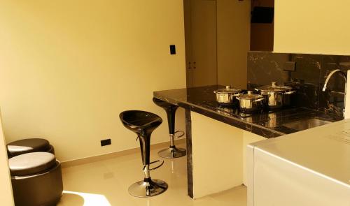 a kitchen with a counter with pots and pans on it at ChezElena suites & apartments in Quito