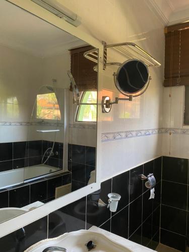 a bathroom with a sink and a mirror at Seafront Residences in Bijilo