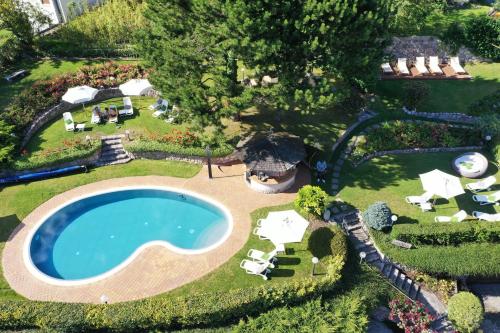 an aerial view of a backyard with a swimming pool at Hotel Du Lac in Molveno